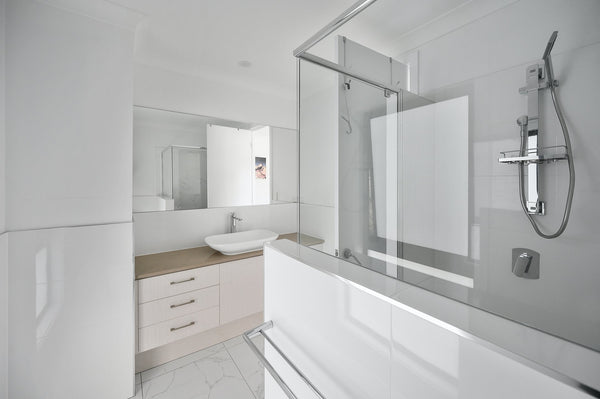 white bathroom with polished chrome shower fixtures